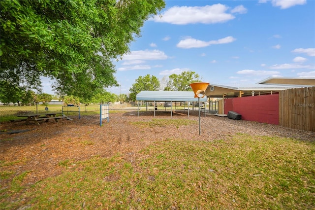 view of yard with a carport and an outdoor structure