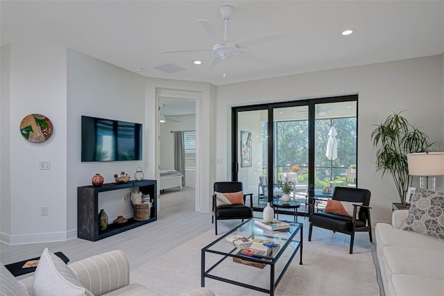 living area featuring recessed lighting, a ceiling fan, baseboards, visible vents, and light wood-type flooring