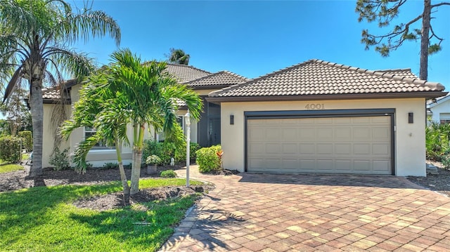 view of front of house featuring a tile roof, decorative driveway, and stucco siding