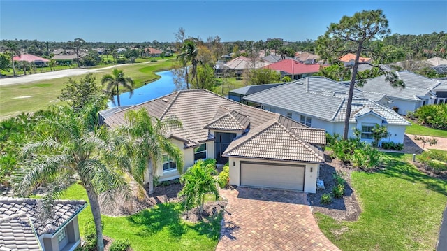 drone / aerial view with a water view and a residential view