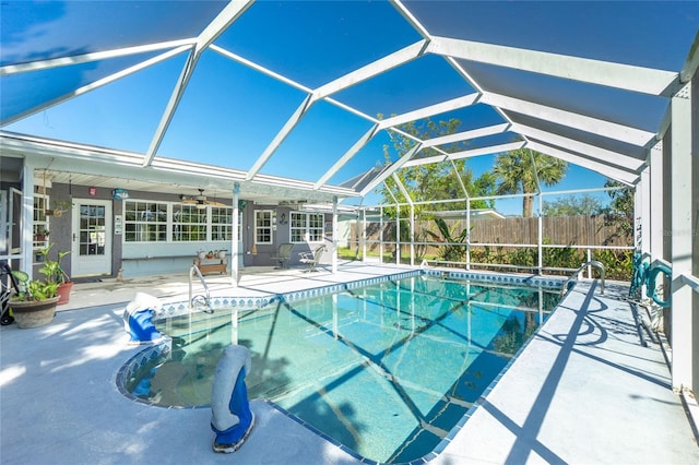 view of swimming pool with a patio, fence, a fenced in pool, ceiling fan, and a lanai