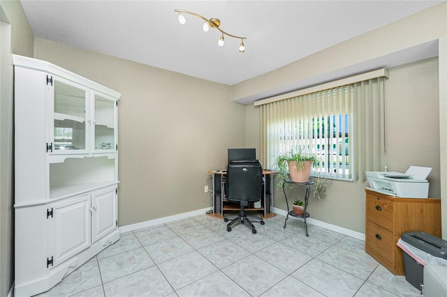 office space featuring baseboards and light tile patterned flooring