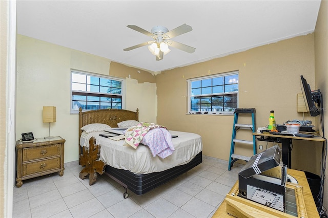 bedroom with light tile patterned floors, multiple windows, and ceiling fan