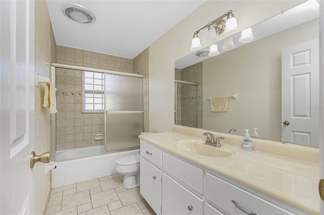 bathroom featuring vanity, toilet, visible vents, and enclosed tub / shower combo