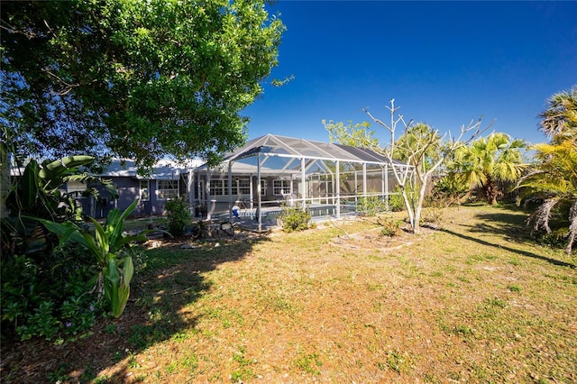 view of yard with a lanai and a swimming pool