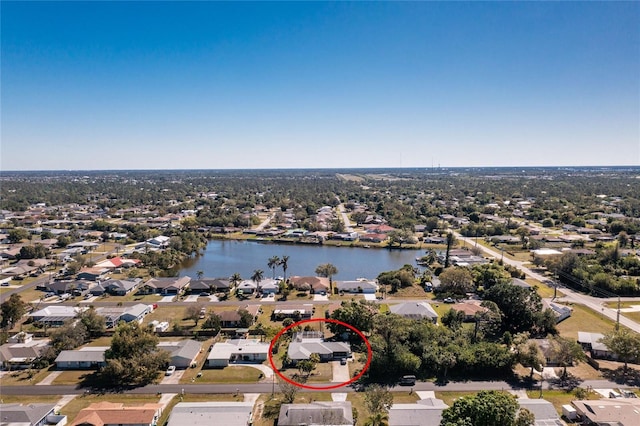 birds eye view of property with a water view and a residential view