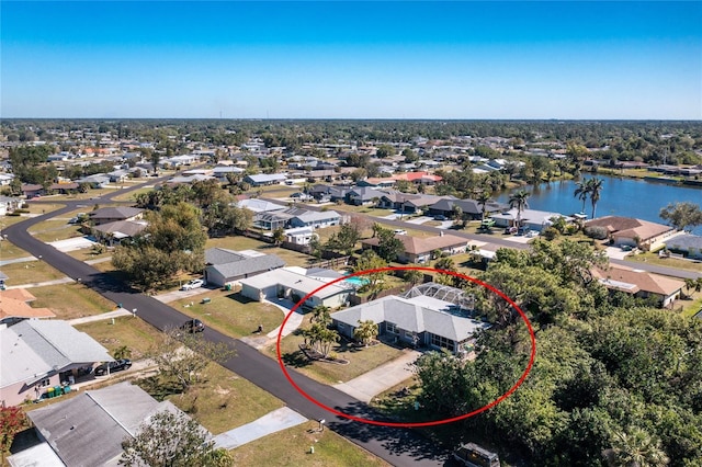 birds eye view of property featuring a water view and a residential view