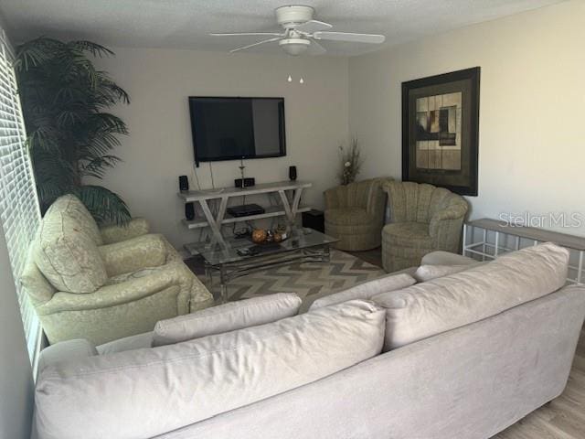 living room featuring a ceiling fan and wood finished floors