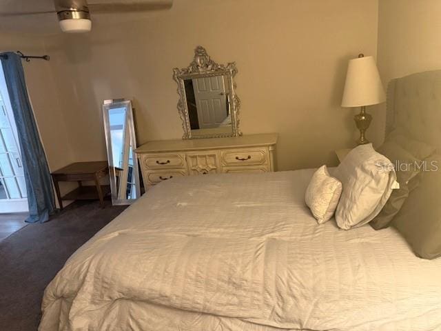 bedroom featuring dark colored carpet and ceiling fan