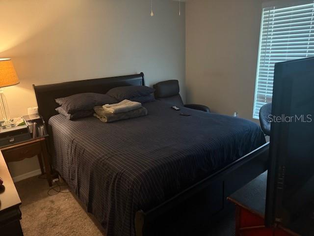 bedroom with light colored carpet