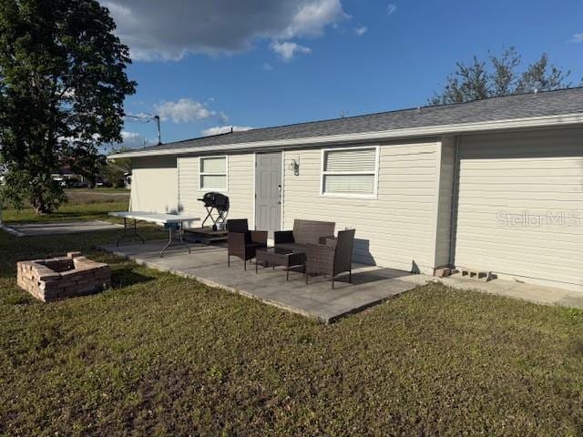 rear view of property with an outdoor hangout area, a yard, and a patio area