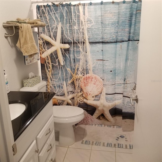 full bathroom featuring toilet, curtained shower, vanity, and tile patterned floors