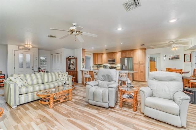 living area featuring recessed lighting, visible vents, ceiling fan, and light wood-style flooring