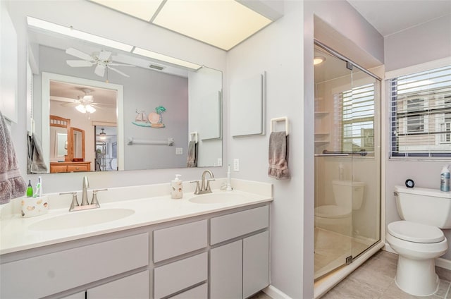 bathroom with toilet, a stall shower, and a sink