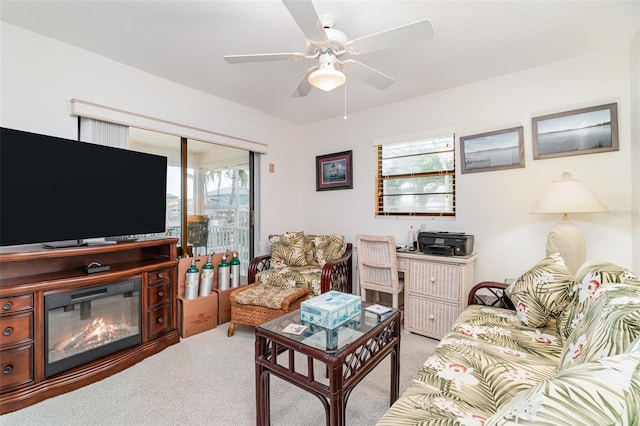 carpeted living area with a ceiling fan and a healthy amount of sunlight