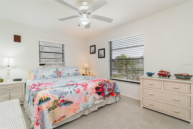 bedroom with baseboards, ceiling fan, and light colored carpet