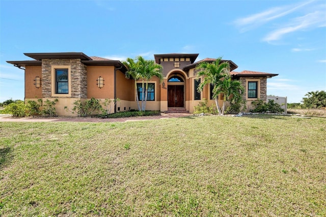 view of front of house featuring stone siding, a front lawn, and stucco siding