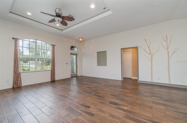 unfurnished room featuring recessed lighting, a raised ceiling, a ceiling fan, wood finished floors, and baseboards