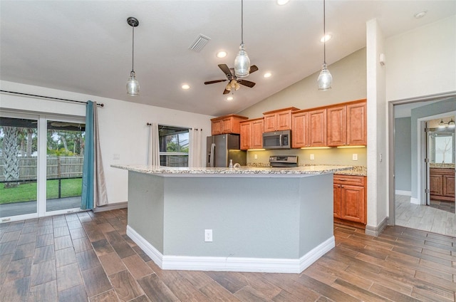 kitchen with stainless steel appliances, wood finish floors, visible vents, and a ceiling fan