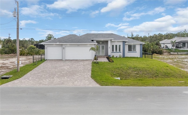 ranch-style house with a garage, fence, decorative driveway, stucco siding, and a front lawn