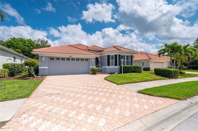 mediterranean / spanish house featuring a garage, a front yard, a tile roof, and stucco siding