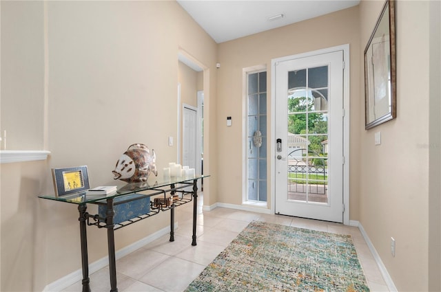 entryway with light tile patterned flooring, visible vents, and baseboards