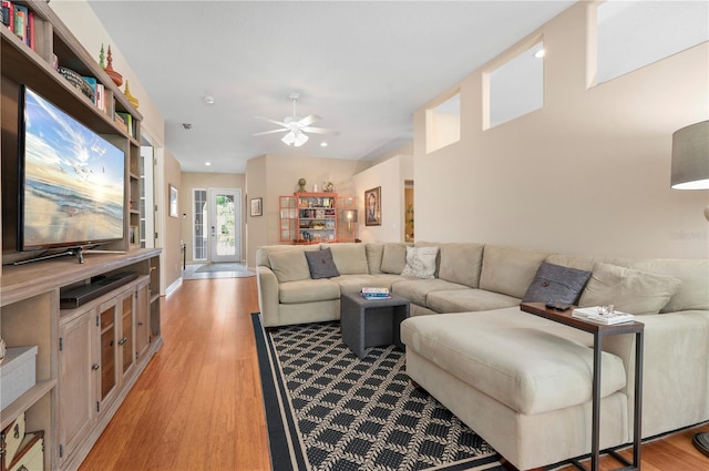 living area with light wood-type flooring and ceiling fan