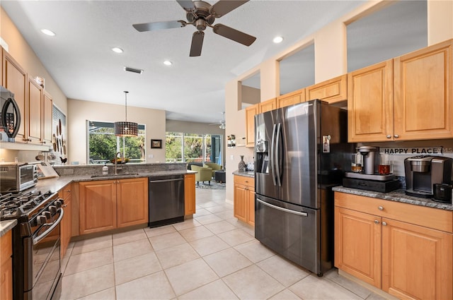 kitchen featuring stainless steel refrigerator with ice dispenser, a sink, black gas stove, a peninsula, and dishwashing machine