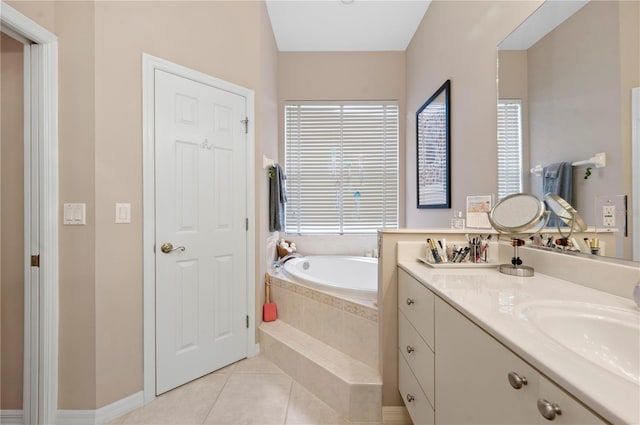 bathroom with tile patterned floors, a bath, and vanity