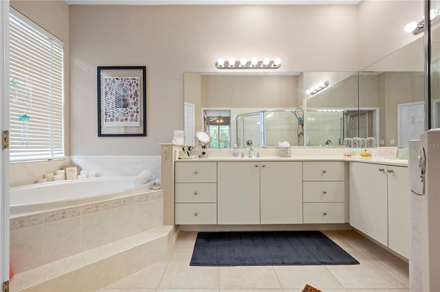 bathroom with a stall shower, vanity, a bath, and tile patterned floors