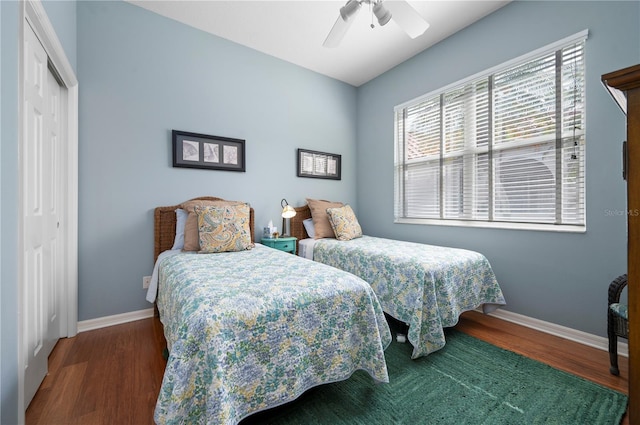 bedroom featuring a closet, baseboards, and wood finished floors