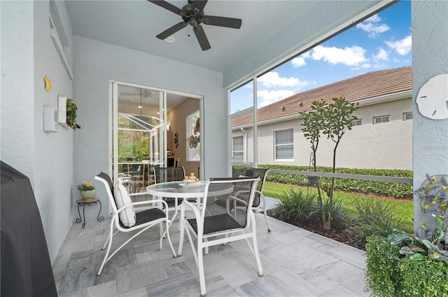 sunroom with a ceiling fan