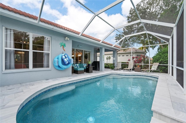 pool featuring glass enclosure, a patio area, and outdoor lounge area