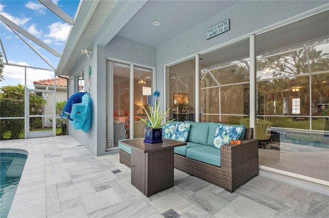 view of patio with an outdoor hangout area, glass enclosure, and an outdoor pool