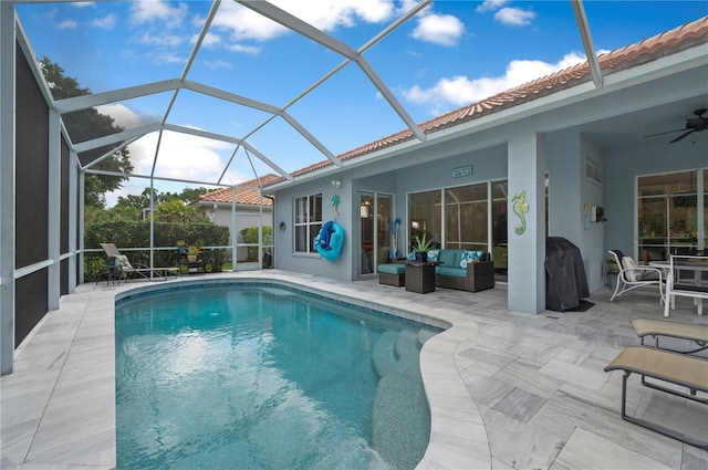 outdoor pool with a lanai, outdoor lounge area, a ceiling fan, and a patio