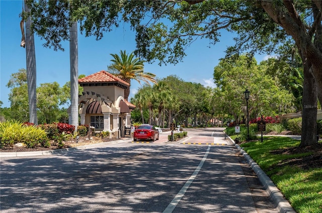 view of street featuring street lighting and curbs