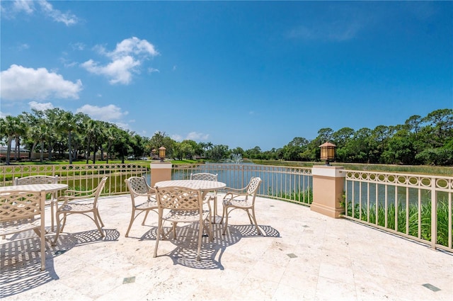 view of patio featuring outdoor dining area and a water view