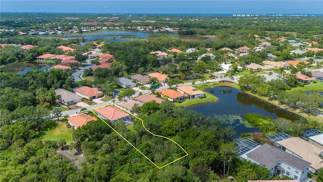 drone / aerial view featuring a residential view and a water view