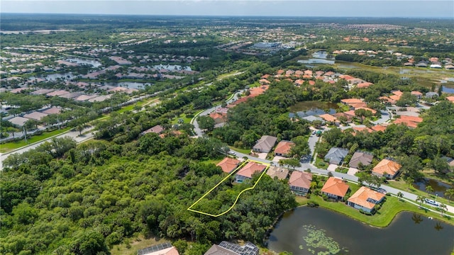 drone / aerial view with a residential view and a water view