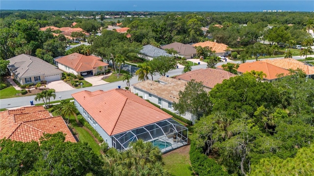 aerial view featuring a forest view and a residential view