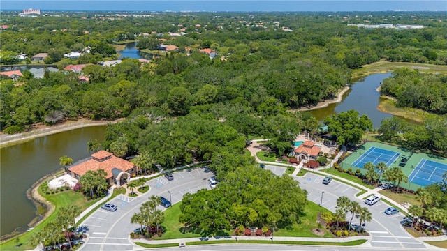 aerial view featuring a water view and a wooded view