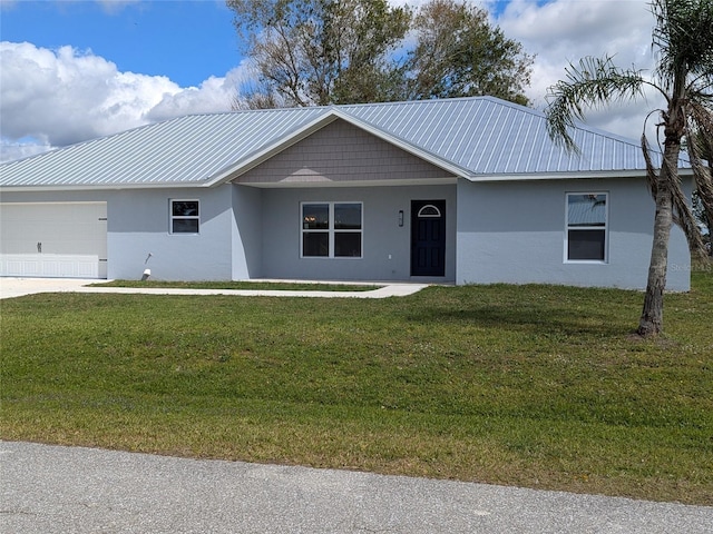 ranch-style house with a garage, a front yard, metal roof, and stucco siding