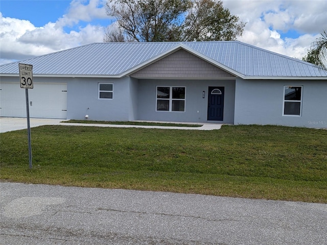 single story home with a garage, a front yard, metal roof, and stucco siding