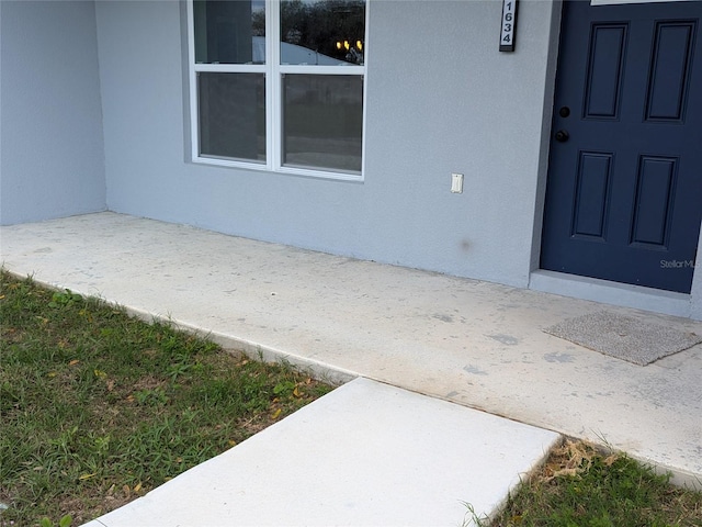 doorway to property with stucco siding