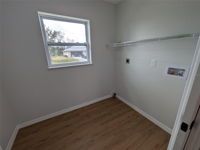 clothes washing area with hookup for a washing machine, laundry area, electric dryer hookup, and baseboards