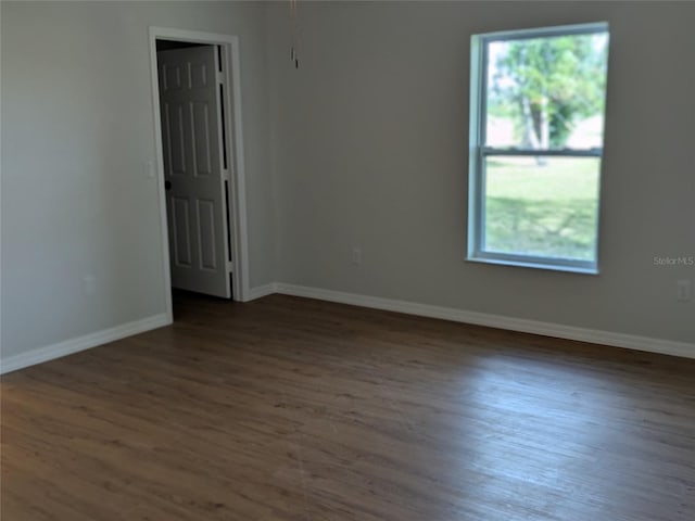 unfurnished room with wood finished floors and baseboards