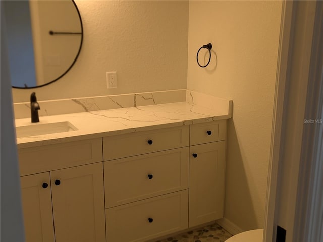 bathroom with toilet and vanity