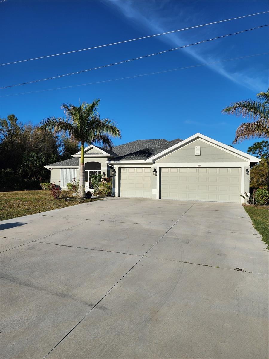 view of front facade with concrete driveway, an attached garage, and stucco siding