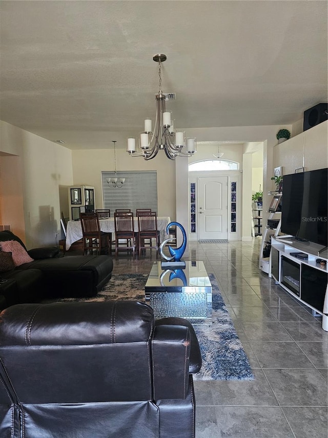 living area featuring a chandelier and visible vents