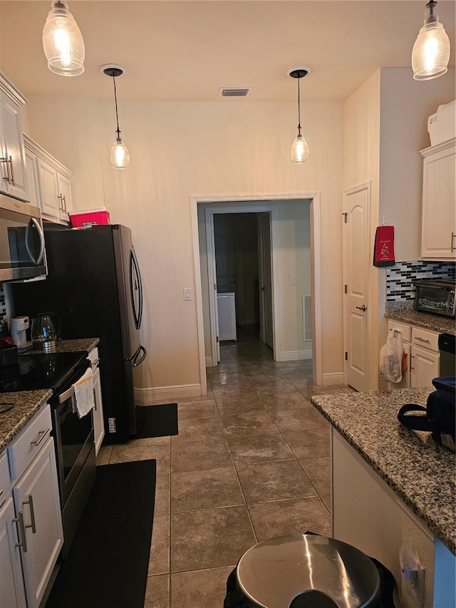 kitchen featuring visible vents, decorative backsplash, hanging light fixtures, white cabinets, and appliances with stainless steel finishes
